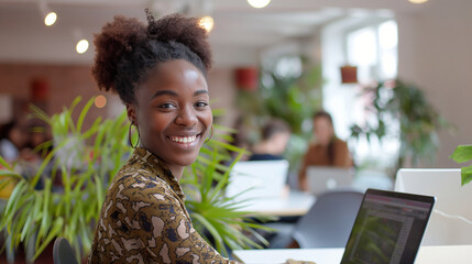 Smiling Woman Working on a Laptop in a Modern Cozy Workspace