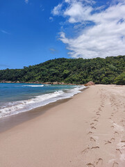 Footprints in the sand at Antigos Beach, a paradisiacal beach in Paraty, Brasil