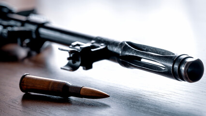 Automat or Kalashnikov carbine on a wooden background