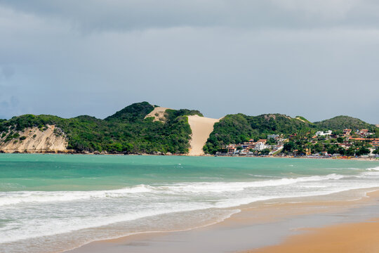 Ponta Negra beach in Natal, Rio Grande do Norte, Brazil. Tropical landscape with Morro do careca and turquoise sea in the cloudy day.