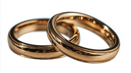 Intricately designed gold wedding bands rest close together, reflecting a warm glow. Their circular forms represent eternal love, promising a lifelong journey of unity and devotion