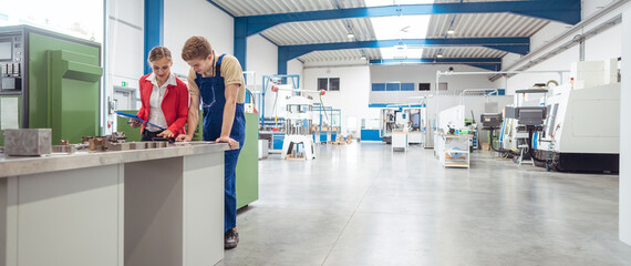 Manufacturing worker and manager during quality inspection of work piece