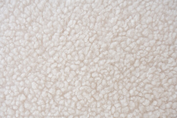 Detailed close-up of plush white sherpa fleece fabric with a wavy, curly pattern
