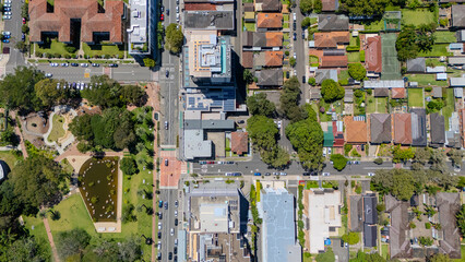 Drone view looking down on Commercial Suburb of Burwood in Sydney residential houses in suburbia suburban houses shops and streets park NSW Australia 