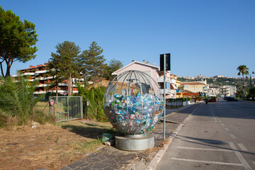 Circular iron bin designed for separate waste collection, specifically for recycling empty plastic bottles responsibly.