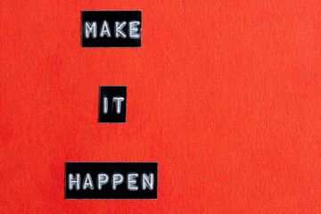 Make it happen words on red background. Motivational and inspirational quote.