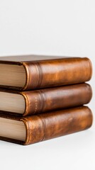 Beautifully crafted vintage books stacked elegantly on a white surface.