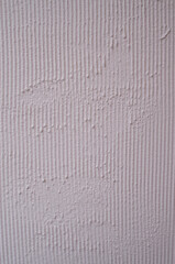 Pink rough plaster on wall closeup
