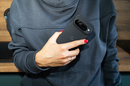 Estonia, Tallinn February 16, 2025. Modern flagship phone Google pixel 9 pro in the hand of a girl at home.