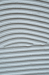 Gray decorative relief plaster on wall closeup