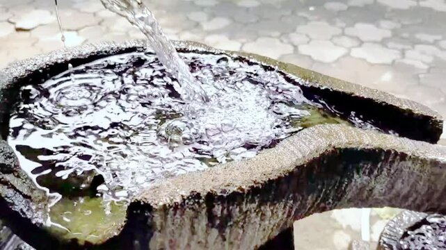 Cinematic shot of a minimalist water feature with a gentle cascading flow