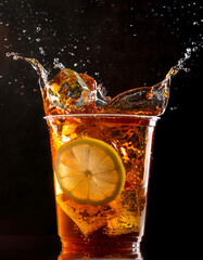 Lemon slice dropped into iced tea, splash effect, high-speed shot