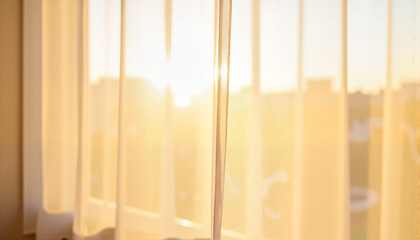 Soft sunlight streaming through sheer curtains in a cozy room for blogs, websites, interior design projects, and warmth-themed materials