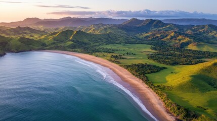 Obraz premium Aerial view of a serene beach, lush green hills, and tranquil waters under a soft sunrise, highlighting nature's beauty and calmness.