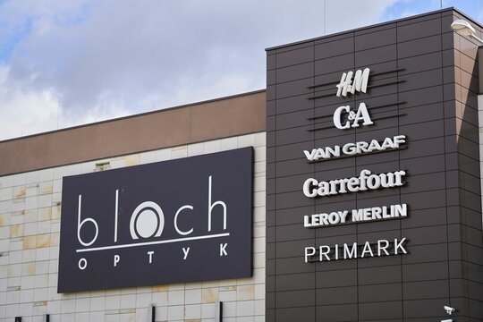 Row of logos on the Posnania shopping mall building, including H&M and C&A, Poznan, Poland