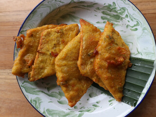 Mendoan tempeh or tempe mendoan served on a plate and lined with banana leaves
