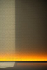 Fototapeta premium Warm Orange Light Illuminates Textured Wall