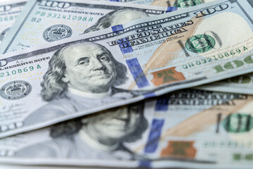 Hundred dollar bills are scattered on the table. Finance of the United States of America.