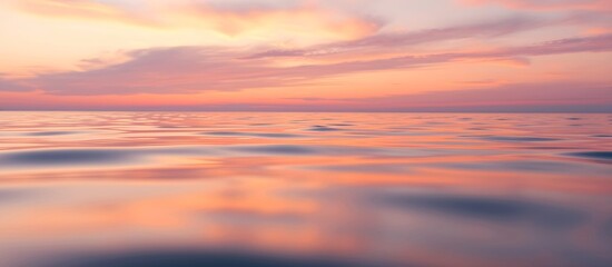 Fototapeta premium Sunset over a calm pink sea.