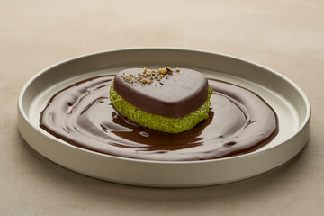 Close up of a dark Dubai chocolate plated on modern whote plate, ready to eat.  A la carte creative concept, studio shot