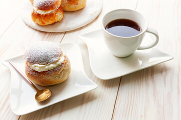 Homemade Semla or semlor, vastlakukkel, laskiaispulla - traditional Scandinavian sweet bun especially Fastelavn Shrove Monday and Shrove Tuesday.