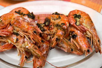Grilled king prawns served on a white plate