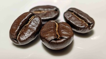 Obraz premium Glossy Roasted Coffee Beans in Close-Up Detail on White Surface