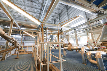 A modern chemical plant featuring extensive pipelines and conveyor systems in operation during the...