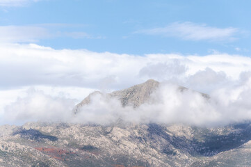 Cumulus Congestus Clouds against blue sky over  montains.