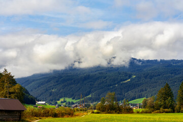 Cumulus Congestus Clouds against blue sky over  montains.