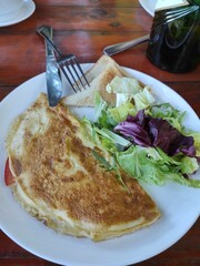 Delicious Breakfast: A Fresh Omelette with Salad and Toast