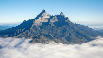 The majestic Qixing Mountain peaks rising above the clouds, with clear blue skies and a breathtaking view of Taiwan highlands and valleys below