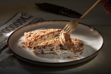 Savoring a scrumptious piece of cake, topped with a delicate crumble, showcasing the craftsmanship of a bakery dedicated to pure ingredients and no additives, inviting a culinary experience