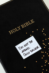 Do not be afraid, only believe, handwritten quote with mustard seeds on holy bible book. Top view. Faith in God Jesus Christ, biblical concept.	