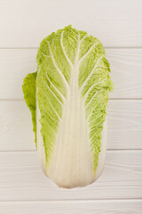 chinese cabbage on white wood background top view