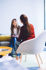 Modern stylish coworkers sitting in workplace