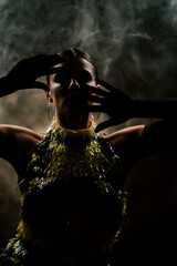 Captivating latina dancer performs sultry routines in dark smoky atmosphere with rhythmic passion