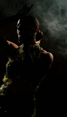 Dancer performs elegant bachata moves in a smoky atmosphere during a captivating dark setting