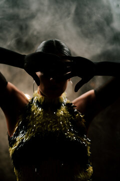Dancing silhouette of a Latina woman in smoke performing bachata and rumba at night