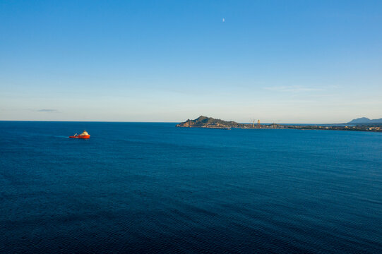 Boats in front of the town of Arbatax in Europe, Italy, Sardinia, Arbatax, in summer, on a sunny day.