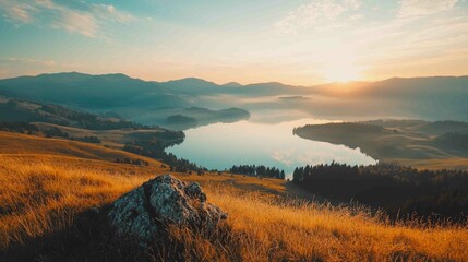 Obraz premium Serene Morning View from Ridge Overlooking Still Water and Mountains