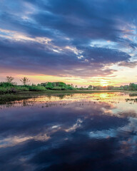 Beautiful sunset over a lake with a reflection of the sky on the water