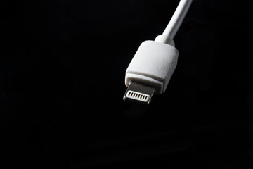 White Charging Wire on Black Background