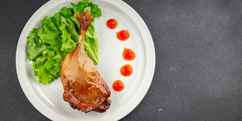 Duck leg confit baked bird meat fresh tasty food dish delicious gourmet food background on the table rustic food top view copy space