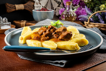 Beef stew in gravy served with potato dumplings.