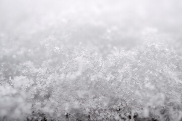 close-up photograph of a snow texture, individual flakes are visible, macro photography taken from different angles and differentiated focus