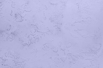 Textured light purple plaster wall with artistic abstract patterns and shadows