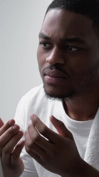 Vertical video. Skin problem. Acne treatment. Allergy irritation. Annoyed dissatisfied disturbed man touching dry face looking in mirror.