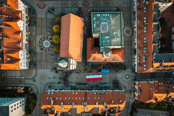 Aerial photo of small city center with Polish flag © Anna