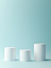 Display of Three White Cylindrical Pedestals Against a Light Blue Background Showcasing Modern Minimalism and Design Aesthetics